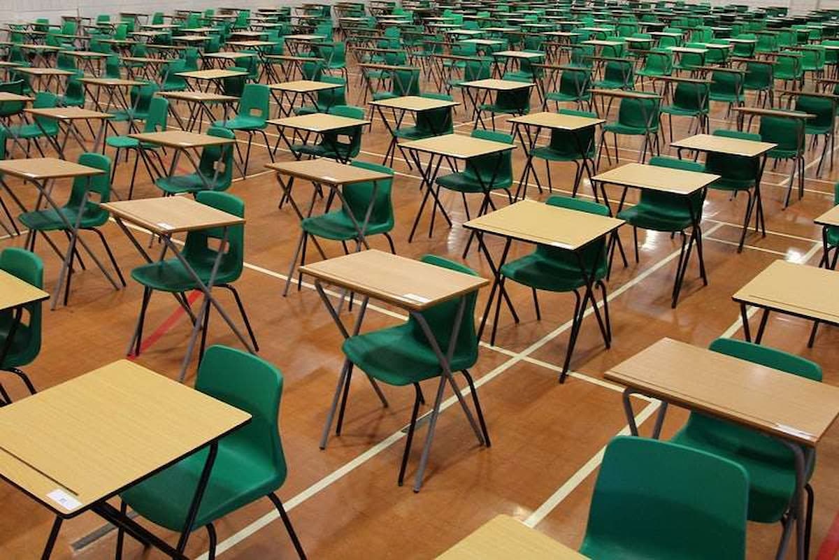Exam hall with tables and chairs. This image accompanies an article titled 'The South African province that bucked national trends by cutting education funding'